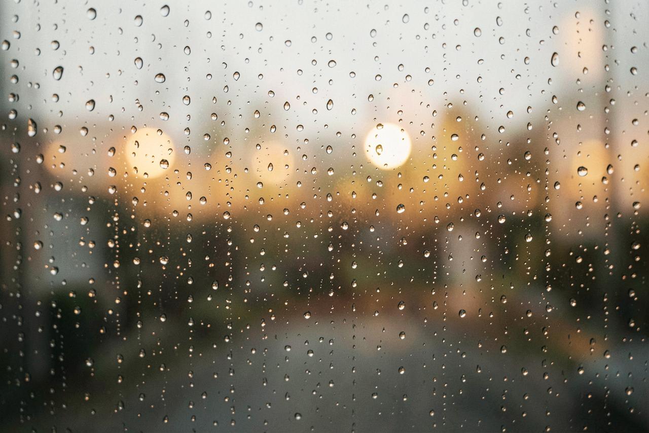 Rain on a window with soft blurred lights